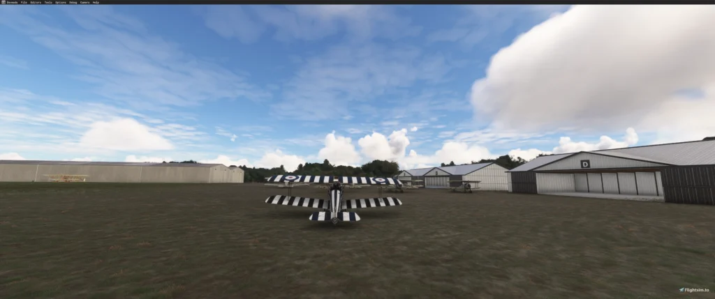 Campo gramado do Grange Aerodrome 1917 com hangares e biplanos no Microsoft Flight Simulator