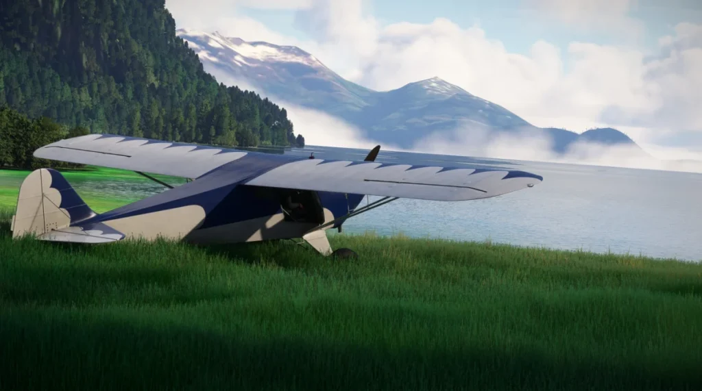 Taylorcraft BC-12D azul em cenário de montanha e lago
