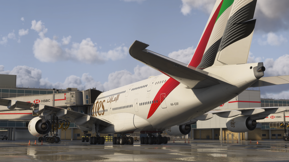 iniBuilds London Heathrow para MSFS 2024 com múltiplas jetways conectadas a uma aeronave em gate